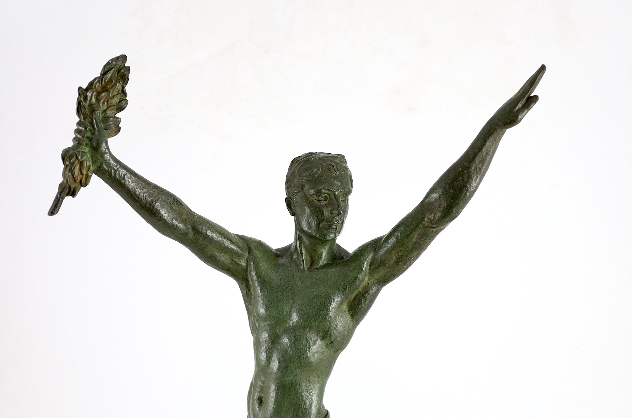 J. Darcourt. NB. An Art Deco patinated spelter figure of a victorious athlete, depth 15cm height 63cm